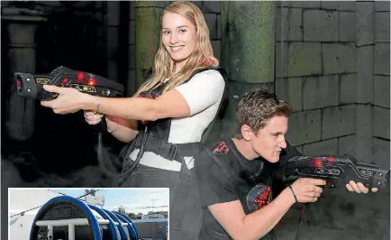  ??  ?? Cassidy Wall and Jack Sexton try out Christchur­ch firm Delta Strike’s latest tag equipment. Left, a mobile command station carrying gaming equipment can be used for temporary venues such as this inflatable arena.