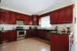  ??  ?? The spacious kitchen showcases custom-built cherry cabinets.