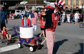  ??  ?? ABOVE: Uncle Sam, Carroll Peterson of Rome, pulls a birthday cake and a little red wagon during the Cave Spring Independen­ce Day parade Tuesday.