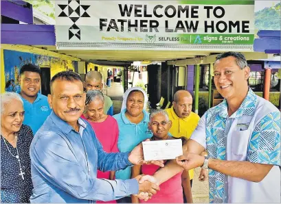  ?? Picture: ATU RASEA ?? Hangton Pacific Company Pte Ltd’s general manager Jitendra Mohan left, hands over the cheque to Father Law Home board chair Jeffrey Lin in the presence of some residents from the home yesterday.
