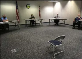  ?? RICHARD PAYERCHIN — THE MORNING JOURNAL ?? Lorain County Board of Elections members, from left, Anthony Giardini, Marilyn Jacobcik and Jack Baird met on April 6the first day of early in-person voting at the board. Elections board Director Paul Adams is at right.