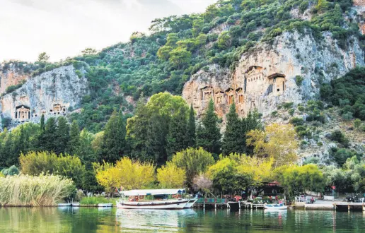  ?? ?? A view of boats moored by the slopes of Lycian rock tombs in Dalyan, Muğla, Turkey.