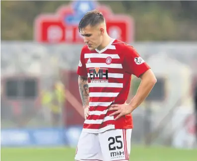  ??  ?? Dejected Scott Martin’s expression at the final whistle say it all