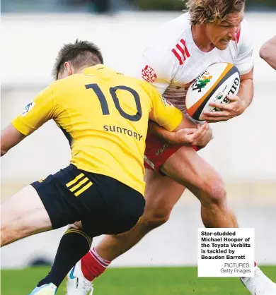  ?? PICTURES: Getty Images ?? Star-studded Michael Hooper of the Toyota Verblitz is tackled by Beauden Barrett
