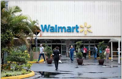  ?? Bloomberg News ?? Customers walk outside a Walmart store in Sao Paulo, Brazil, in this 2016 file photo. Walmart said Monday that a private equity investment firm was buying a majority stake in Walmart Brazil.