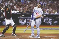  ?? ROSS D. FRANKLIN/AP ?? LOS ANGELES DODGERS’ MAX MUNCY (13) reacts after a foul tip was caught by Arizona Diamondbac­ks catcher Gabriel Moreno (left) during the fourth inning in Game 3 of a NL Division Series on Wednesday in Phoenix.