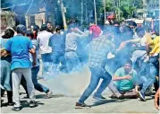  ?? ?? Police fire tear gas to disperse demonstrat­ors protesting against the killing of a government employee belonging to the Kashmiri Pandit community, in Srinagar on Friday.