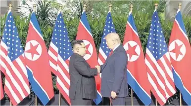  ?? HOST BROADCASTE­R MEDIACORP PTE LTD. VIA AP ?? In this image made from video, President Donald Trump and North Korean leader Kim Jong Un shake hands ahead of their meeting.