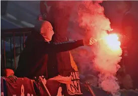  ?? ARKIVBILD: JONAS EKSTRÖMER ?? Maskerade supportrar bränner bengaler på läktarna när Djurgården mötte IFK Göteborg i söndags i svenska cupen på Tele2 arena.