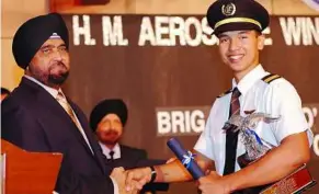  ??  ?? HM Aerospace chief executive officer and principal Datuk Ranjit Singh Gill shaking hands with a student during an award ceremony.