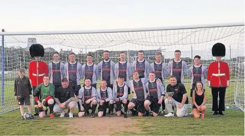  ??  ?? Llangoed – winners of the Bwlch Car Boot Trophy – were joined by members of the Welsh Guards for an after-match photograph. The Guards also led a minute’s silence for the Manchester victims and their families