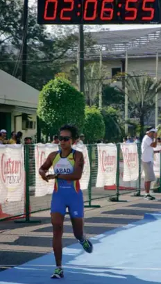  ??  ?? MONDAY, NOVEMBER 26, 2012 FILIPINA Mirasol Abad stops her watch as she crosses the finish line third in the women’s Elite division at Subic Freeport.