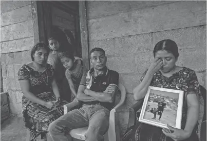  ?? PHOTOS BY OMAR ORNELAS / EL PASO TIMES ?? Catarina Tambriz Tambriz holds a photo of her dead son Diego Tzaj Ixtos as her husband, Francisco Tzaj Quemá, and their three daughters look on. Tzaj Ixtos died in a March 27, 2023, fire in a migrant detention center fire in Juárez, Mexico.