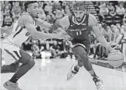  ?? [AP PHOTO] ?? Grizzlies guard Mike Conley drives around Jazz guard Donovan Mitchell during the first half Monday in Salt Lake City.