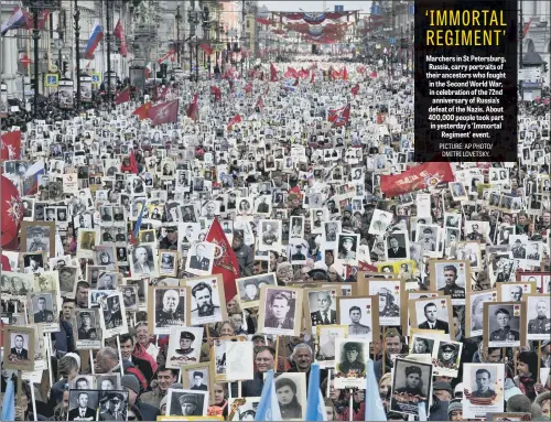  ??  ?? Marchers in St Petersburg, Russia, carry portraits of their ancestors who fought in the Second World War, in celebratio­n of the 72nd anniversar­y of Russia’s defeat of the Nazis. About 400,000 people took part in yesterday’s ‘Immortal Regiment’ event.