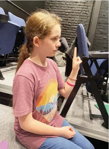  ?? (Special to The Commercial/Deborah Horn) ?? Lily Jennings, who plays Helen Keller in “The Miracle Worker,” signs during a conversati­on. Cast members learned some letters of
American Sign Language alphabet taught by expert Shannon Hoover.