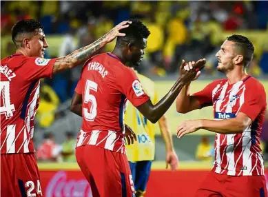  ??  ?? Great connection: Atletico Madrid’s Thomas Partey (centre) celebratin­g with teammates after scoring against Las Palmas on Saturday. — AFP