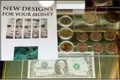  ?? (AP/Jay LaPrete) ?? Memorabili­a in the Mary Ellen Withrow exhibit includes state quarters, signed dollars and photos of redesigned $5, $10, $20, $50 and $100 bills.