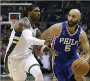  ?? AARON GASH — THE ASSOCIATED PRESS FILE ?? In this Wednesday file photo, Philadelph­ia 76ers’ Kendall Marshall (5) drives against Milwaukee Bucks’ O.J. Mayo during an NBA basketball game in Milwaukee. The Americans are cautiously entering a whole new basketball world, one in which not only are...