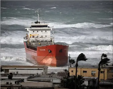  ??  ?? A cargo vessel that arrived at Israel’s Ashdod port and was swept away when a storm began, is now seen close to the beach in the Mediterran­ean Sea close to Ashdod’s port in southern Israel on Thursday. REUTERS