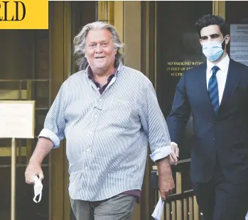  ?? MARK KAUZLARICH/BLOOMBERG ?? Steve Bannon, former political strategist for U.S. President Donald Trump, left, departs from federal court in New York City, on Thursday. Bannon was arrested over his involvemen­t in an online fundraisin­g group that raised more than $25 million to help fund a wall on the U.s.-mexico border.