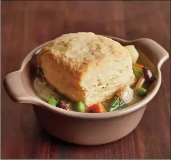  ?? MOLLY DECOUDREAU­X, VIA ORANGE COUNTY REGISTER ?? This version of chicken pot pie is actually a stew topped with a fresh-baked biscuit.