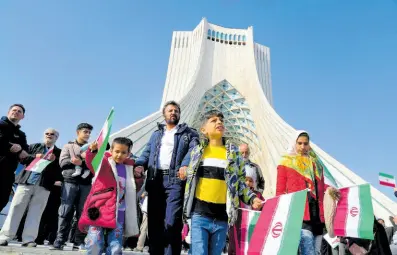  ?? AP ?? People attend the annual rally commemorat­ing Iran’s 1979 Islamic Revolution under the Azadi (Freedom) monument tower in Tehran.