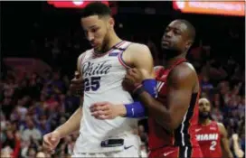  ?? CHRIS SZAGOLA — THE ASSOCIATED PRESS ?? Whether or not Joel Embiid is healthy enough to go in Game 3 Thursday, Ben Simmons, left, and the Sixers will have to find a way to be more physical with the Heat and Dwyane Wade.