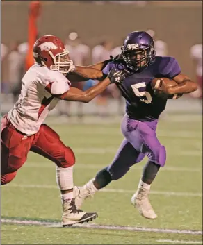  ?? Michael Orrell/News-Times ?? Breaking free: El Dorado's Alex Hicks (5) stiff arms a defender as he picks up yardage in the first half aginst Texarkana on Thurday evening at Memorial Stadium. The ninth-grade Wildcats defeated Texarkana 35-14.