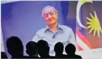  ??  ?? TORU HANAI/REUTERS Malaysia’s Prime Minister Mahathir Mohamad is seen on video conference screen during The Wall Street Journal CEO Council meeting in Tokyo, Japan, on May 15, 2018.