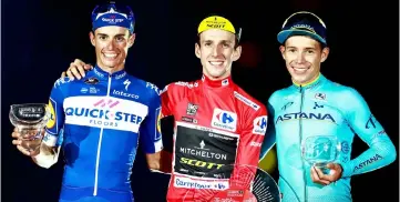  ?? — AFP photo ?? Simon Philip Yates (centre), Quick Step Floors’ Spanish cyclist Enric Mas (left) and Team Astana’s Colombian cyclist Miguel Angel Lopez celebrate on the podium of the 73rd edition of “La Vuelta” Tour of Spain cycling race in Madrid.