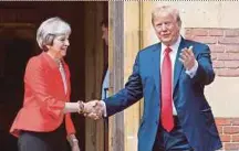  ??  ?? British Prime Minister Theresa May shaking hands with US President Donald Trump as he arrives for a meeting at Chequers yesterday.