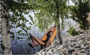  ??  ?? Evgeniy Gultyaev, from Russia, relaxes during the swamp soccer competitio­n