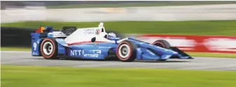  ?? Gary C. Klein / The Post-Crescent ?? Scott Dixon is a blur of action out of turn 5 at the Kohler Grand Prix in Elkhart Lake, Wis.