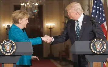  ?? — Reuters ?? President Donald Trump and German Chancellor Angela Merkel shake hands at the conclusion of their joint news conference in the East Room of the White House in Washington on Friday.