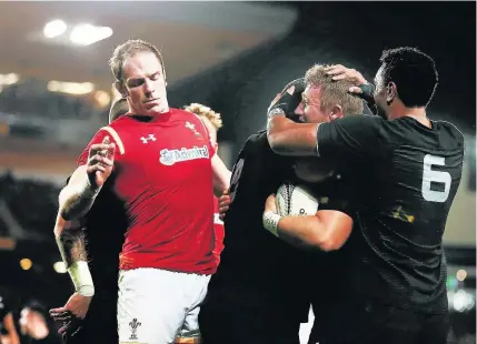  ??  ?? Nathan Harris celebrates New Zealand’s fifth try as Wales’ Alun Wyn Jones looks on during yesterday’s defeat in the opening Test