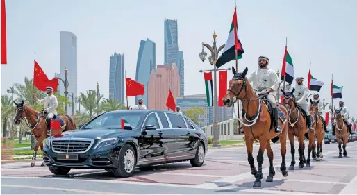  ??  ?? Members of the UAE Armed Forces Cavalry Division escort Xi Jinping upon his arrival at the Presidenti­al Palace for a reception on Friday morning.