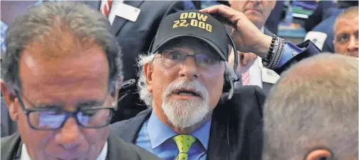  ?? RICHARD DREW, AP ?? Trader Peter Tuchman has the Dow milestone at the top of his mind Wednesday at the New York Stock Exchange.