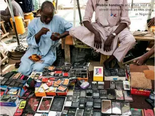  ??  ?? Mobile handsets are often sold at street markets, such as this one in Nigeria