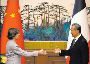  ?? Ng Han Guan
The Associated Press ?? Chinese Foreign Minister Wang Yi, right, reaches out to shake hands with French Foreign Minister Catherine Colonna on Friday in Beijing.
