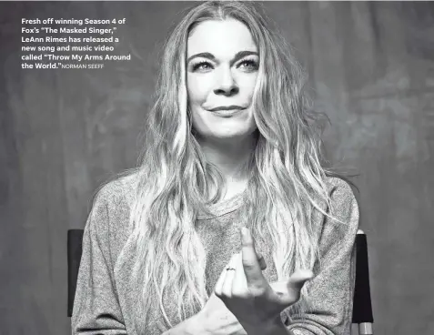  ?? NORMAN SEEFF ?? Fresh off winning Season 4 of Fox’s “The Masked Singer,” Leann Rimes has released a new song and music video called “Throw My Arms Around the World.”