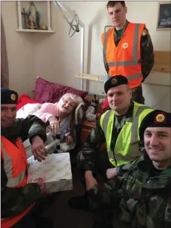  ??  ?? Maura Doyle celebrates her 100th birthday with members of the Defence Forces.