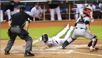  ?? PEDRO PORTAL/TRIBUNE NEWS SERVICE ?? San Francisco Giants catcher Buster Posey, right, waits for a throw as the Miami Marlins' Marcell Ozuna slides safely at home plate after a sacrifice fly by J.T.Realmuto in Miami on Tuesday.