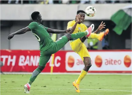  ?? / PIUS UTOMI EKPEI / AFP ?? Nigerian forward Oghenekaro Etebo, left, vies for the ball with Bafana midfielder Themba Zwane during their Afcon qualifier on Saturday. Zwane hit the upright twice.