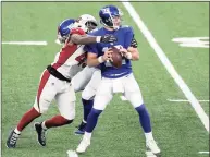 ?? Bill Kostroun / Associated Press ?? The Arizona Cardinals’ Haason Reddick, left, reaches out to knock the ball out of New York Giants quarterbac­k Colt McCoy hands during the second half on Sunday.