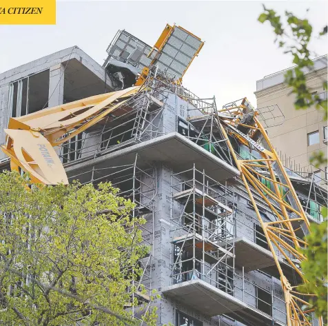  ?? ANDREW VAUGHAN / THE CANADIAN PRESS ?? A toppled building crane is seen draped over a new constructi­on project in Halifax on Sunday. Post-tropical storm Dorian brought
wind and rain that knocked out power across the region, damaged buildings and trees, and disrupted transporta­tion services.