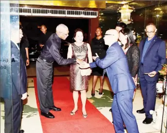  ?? (Ministry of the Presidency photo) ?? President David Granger (second from left) and First Lady Sandra Granger are greeted by President of the ACEG, Kevin Liu upon their arrival at the New Thriving Restaurant on Main Street.