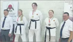  ?? ?? Sensei Alison Hennessy on the winners podium, after taking gold in the Asai kata category, pictured with her fellow competitor­s Sensei Joe Hunter and Shihan Brian Toomey.