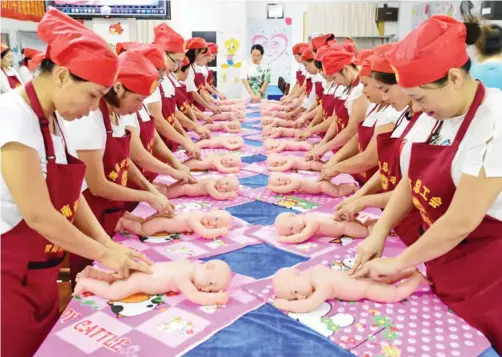  ?? Photo: REUTERS ?? People participat­e in a free infant care training course organized by local labor union in Haikou, Hainan province, China.