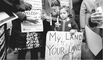  ??  ?? Maya Casillas, 7, attends a vigil in response to Trump’s executive orders relating to immigratio­n, in Los Angeles, California, US on Jan 25. — Reuters file photo